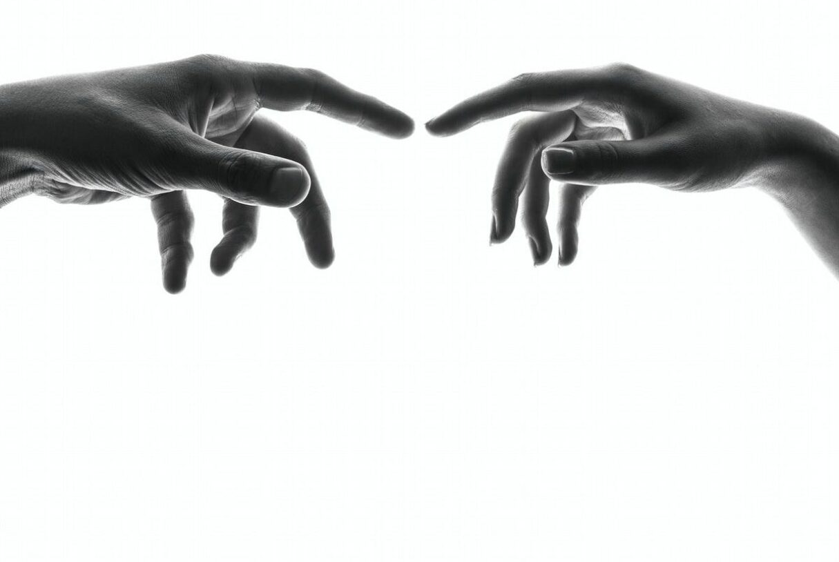 two person's connecting fingers