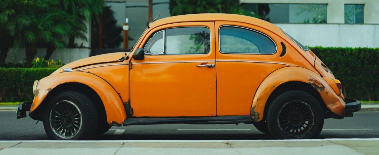 shallow focus photography of orange Volkswagen Beetle