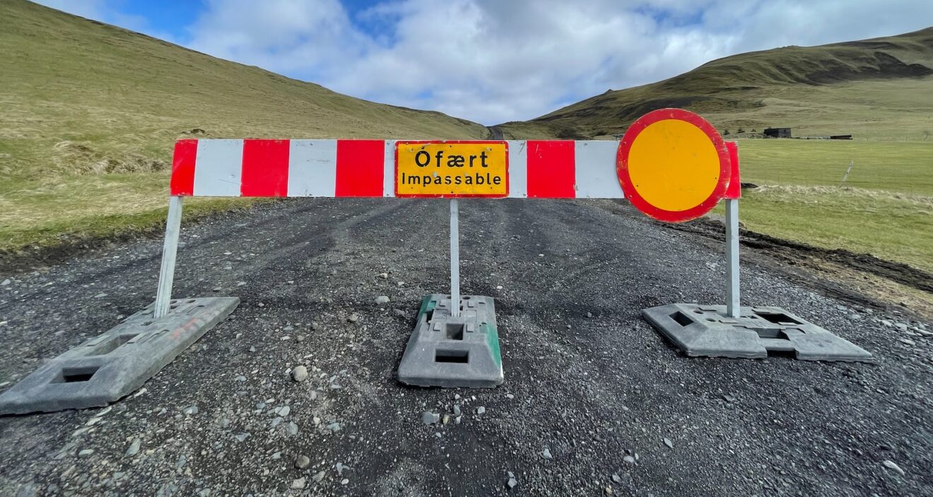a road closed off with a sign on it